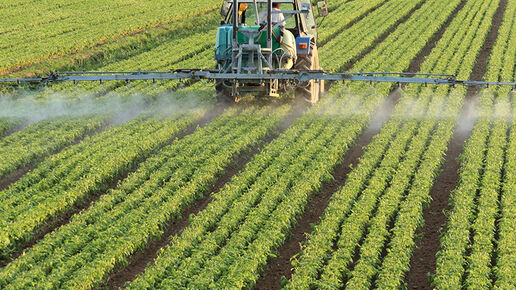 Tractor applying pesticides to a field
