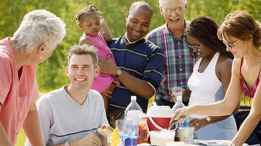 Multi-generation family eating meal around table